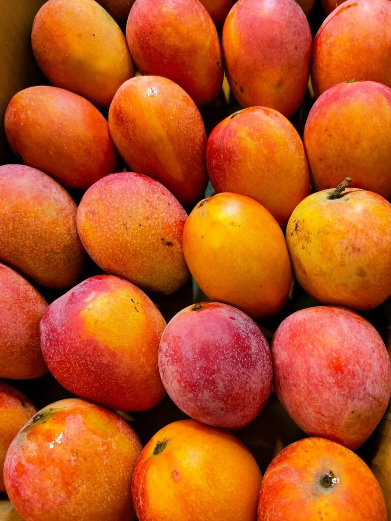 A colorful close-up shot showcasing a collection of fresh ripe mangoes with a vibrant texture.